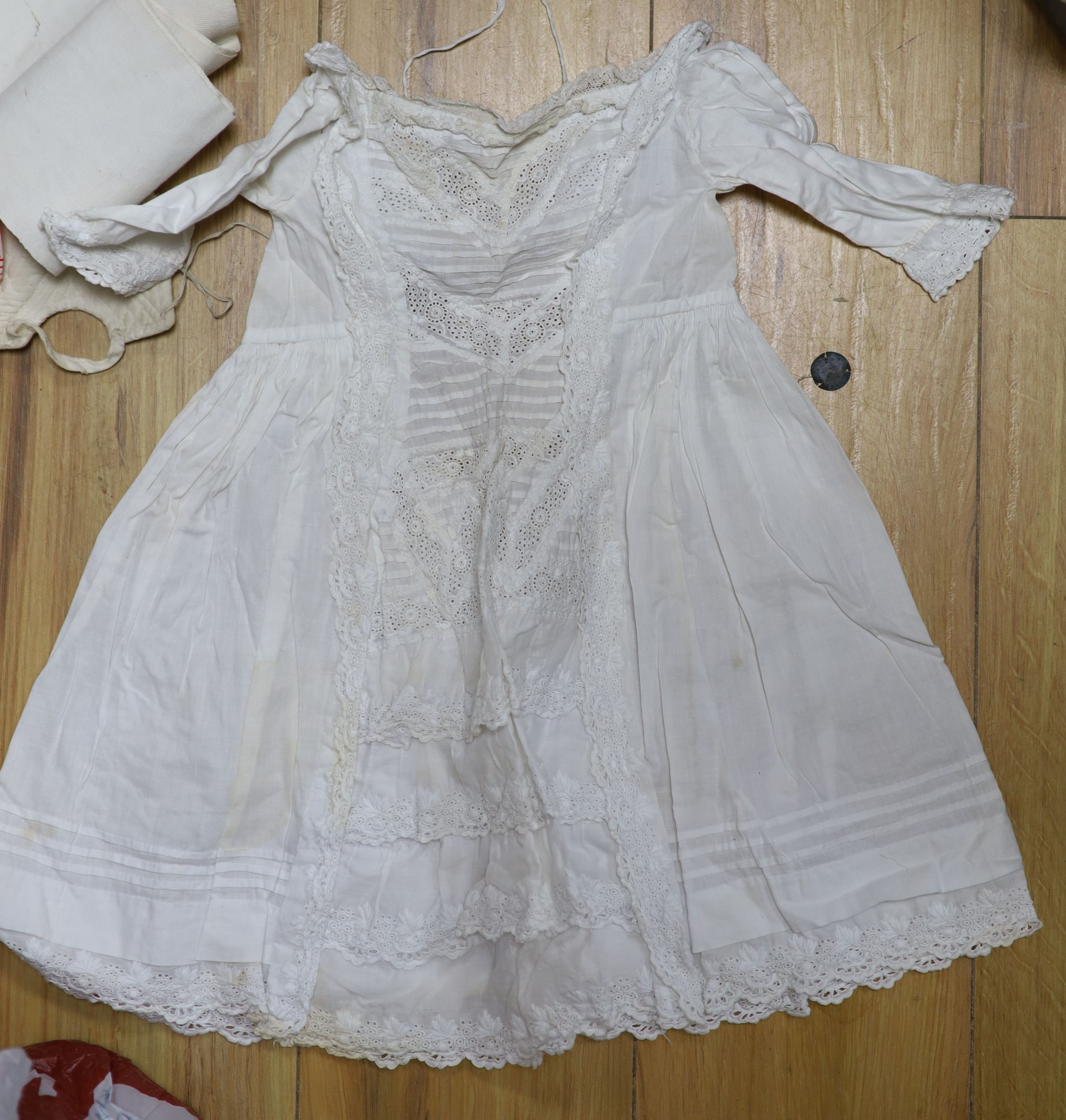 A collection of christening gowns and baby dresses
